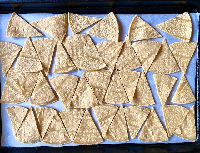Small corn tortillas cut into 8ths and arranged on a parchment lined baking sheet