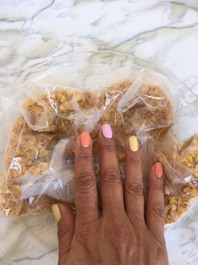 crushing Cornflakes by hand in a freezer bag