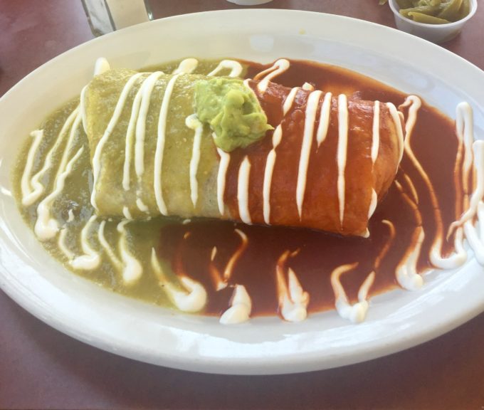 Burrito topped with red and green chile sauce
