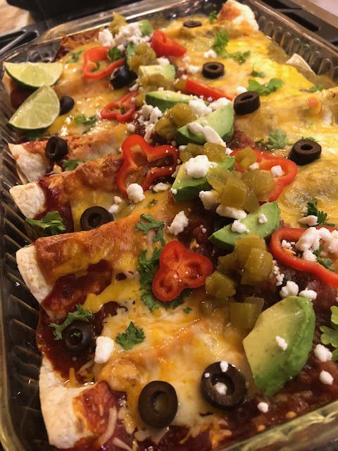loaded christmas enchiladas made with red and green sauce or salsa