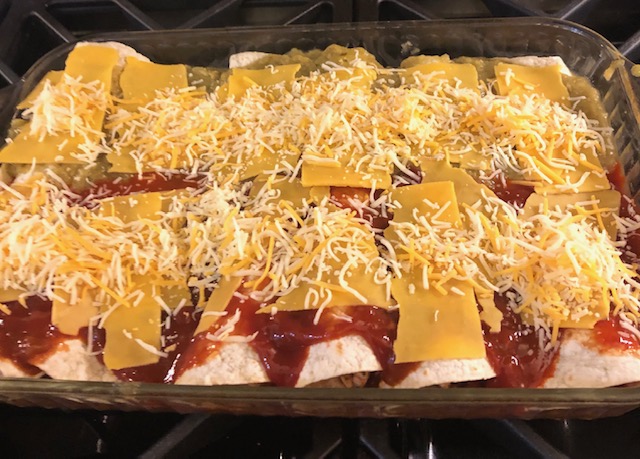 cheesy Christmas enchiladas made with red and green sauce or salsa