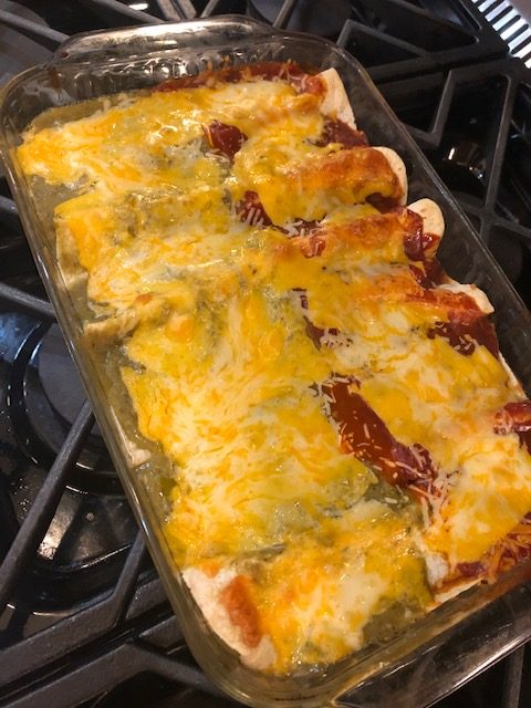 cheesy Christmas enchiladas made with red and green sauce or salsa