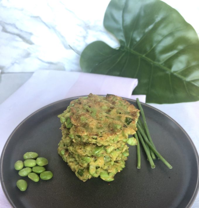 Edamame corn cakes stacked on a plate