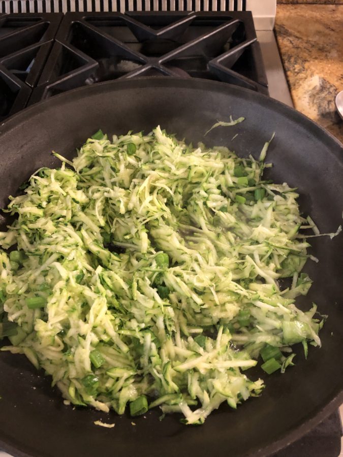 Shredded zucchini cooking in olive oil