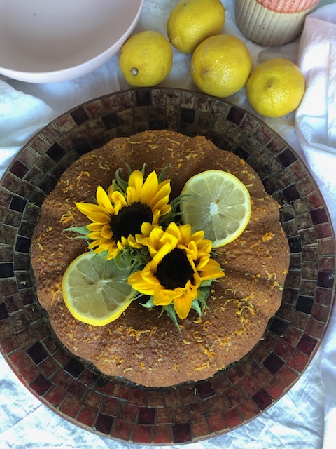 pretty citrus pound cake with fresh sunflowers and lemon wedge