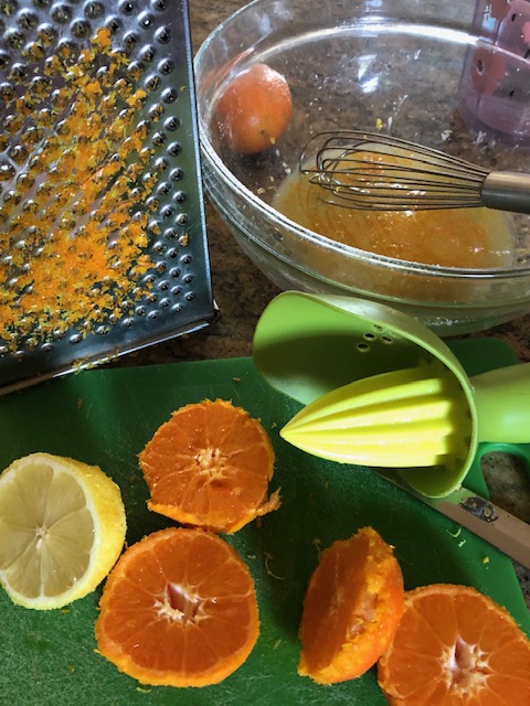 grating lemo and orange rind for zest