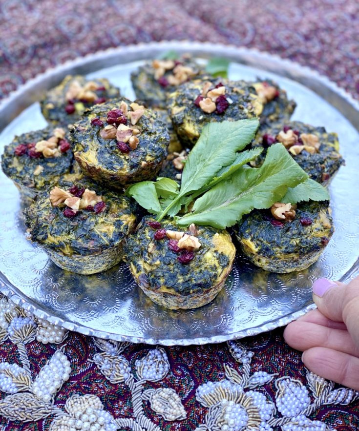 KooKoo Sabzi Muffins plated with fresh herbs