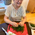 grandma trimming fresh dill for fava bean Persian rice dish