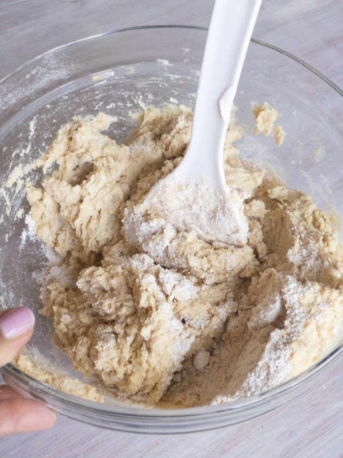 Stirring flour into Persian Pound cake in a bowl