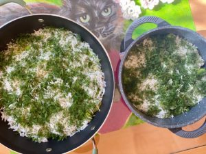 layering polo rice with fresh dill, garlic, saffron, and fava beans