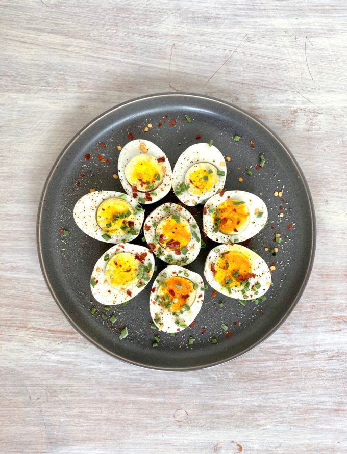Soft boiled Eggs cooked in an Instant Pot sliced and sprinkled with spices