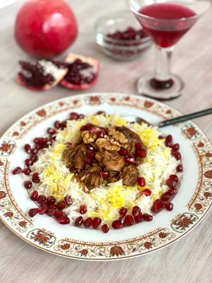 Khoresh Fesenjan Fesenjoon Persian Pomegranate Walnut Chicken Stew served with Rice and garnished with pomegranate arils