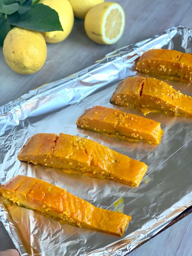 easy Marinated Salmon fillets arranged on a tin foil lined baking sheet