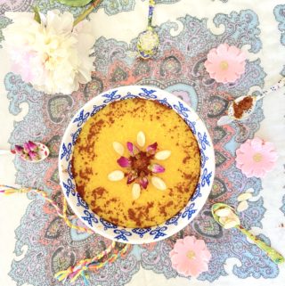 Sholeh Zard Persian Saffron Rice pudding garnished with cinnamon, almonds and rose petals