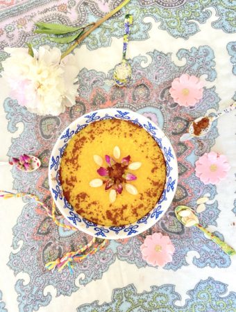 Sholeh Zard Persian Saffron Rice pudding garnished with cinnamon, almonds and rose petals